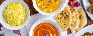 A table set with a variety of Indian foods.